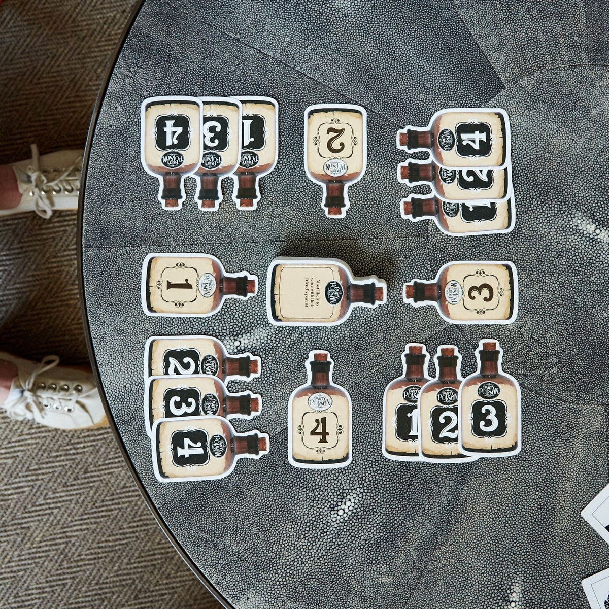 Set of bottle-shaped number cards on a round table