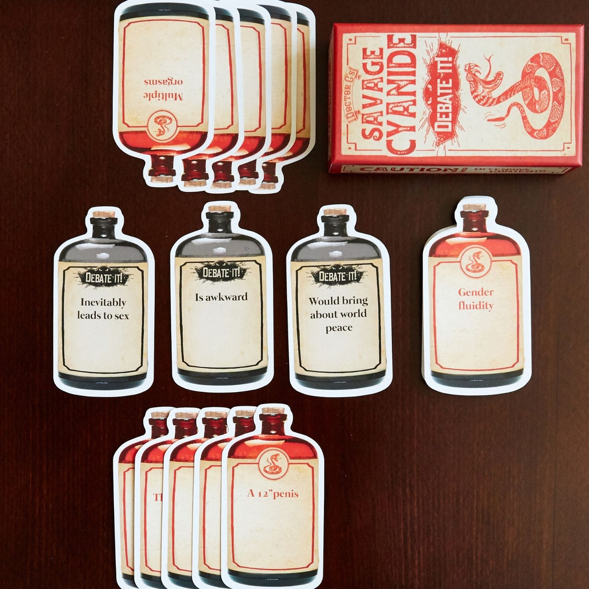 Set of card game cards with humorous labels on a wooden surface