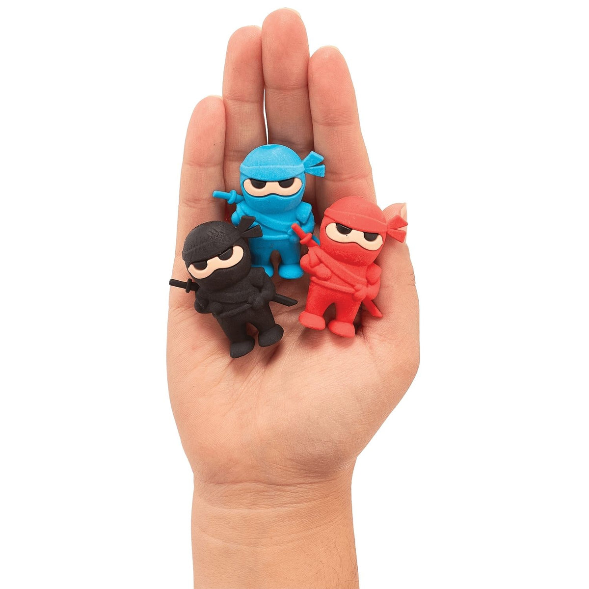 A set of three ninja-themed erasers in blue, red, and black colors packaged in a red box with a clear plastic window displaying the items.