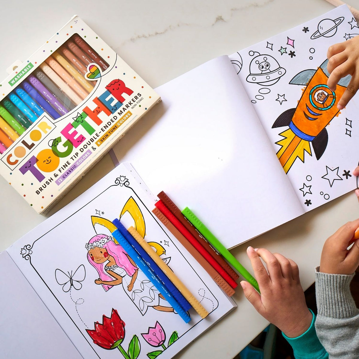 a kid drawing in a colouring book using the colour together markers