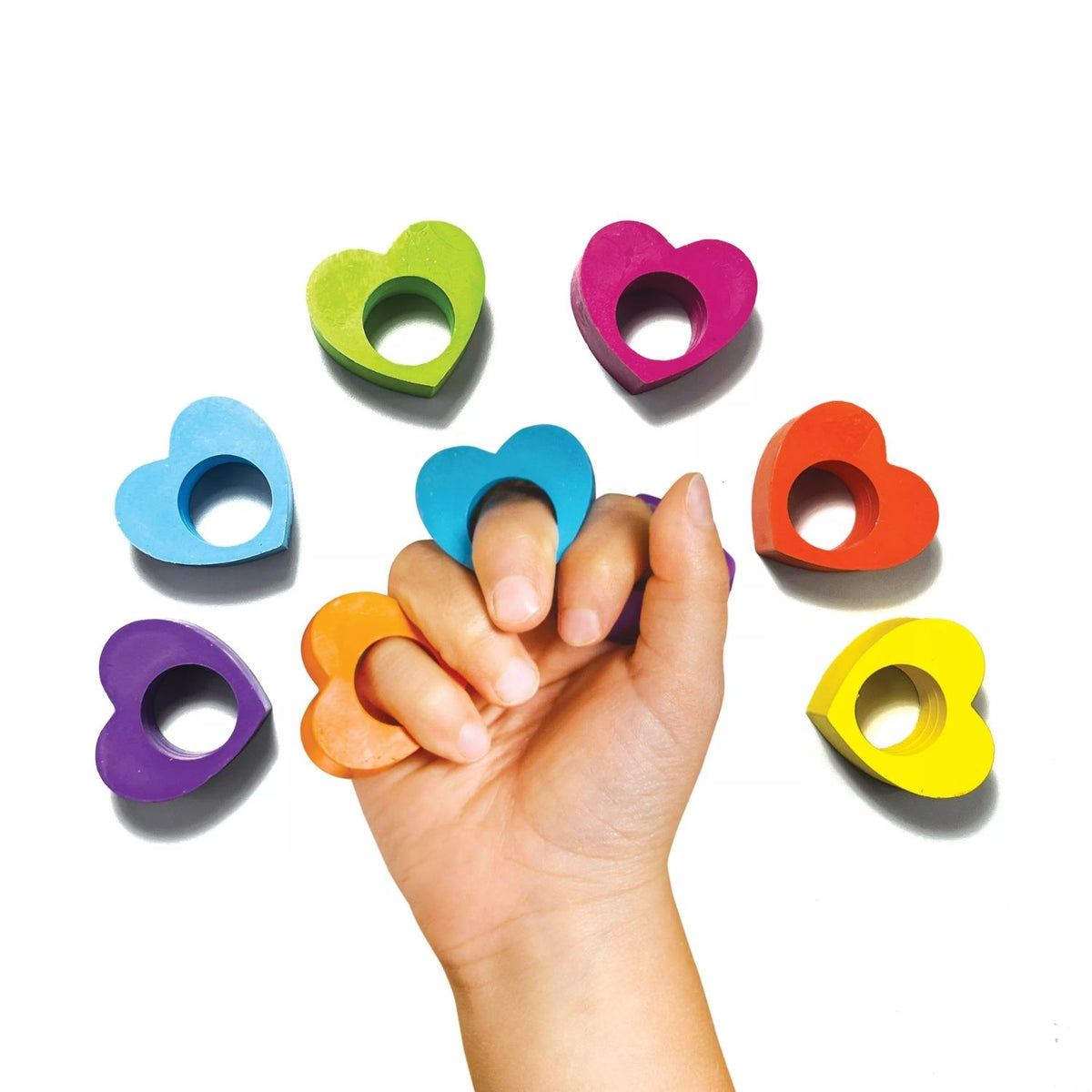 A pack of six heart-shaped ring crayons in rainbow colors, displayed in a clear plastic packaging with a multicolored design at the top.