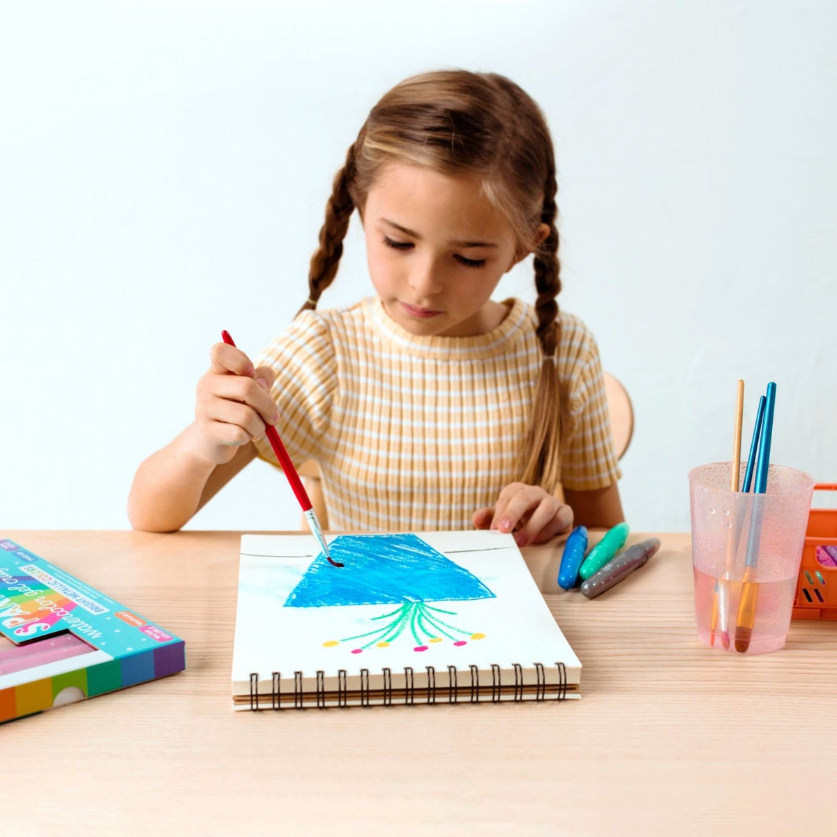 a girl drawing with A set of 12 rainbow sparkle watercolour gel crayons by ooly, 
