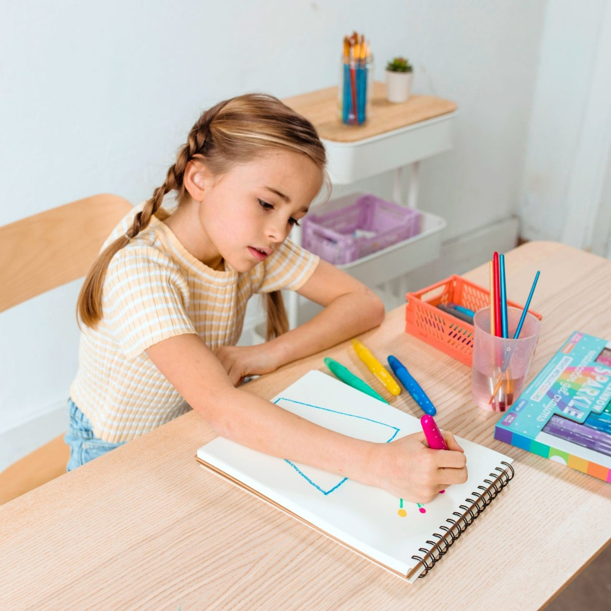 a girl drawing with A set of 12 rainbow sparkle watercolour gel crayons by ooly, 