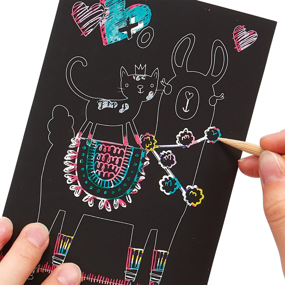A packaged mini scratch and scribble art kit with illustrations of unicorns and other animals, and a wooden scratching tool.