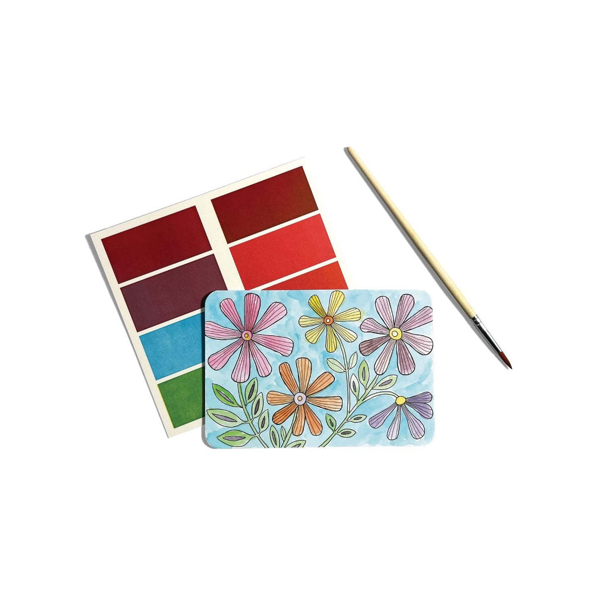 Packaging of Scenic Hues DIY Watercolour Art Kit with illustrations of gardens and flowers, including a paintbrush and color guide.