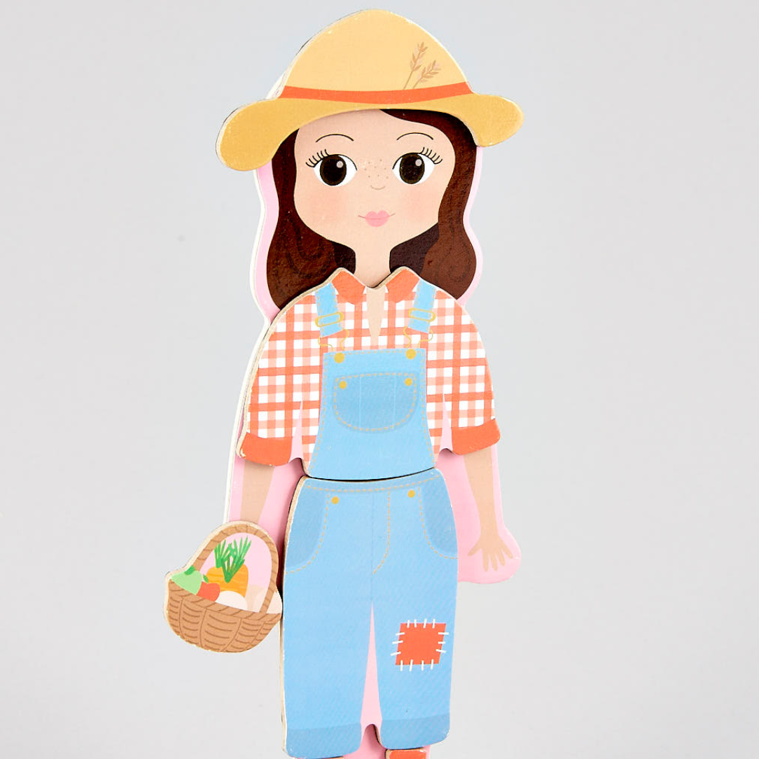 Dress up doll wearing a yellow hat, checkered shirt, and blue overalls holding a basket on a light gray background.