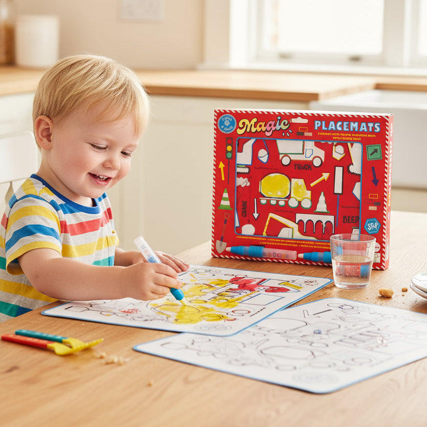 Child playing with educational placemats and markers on a table.