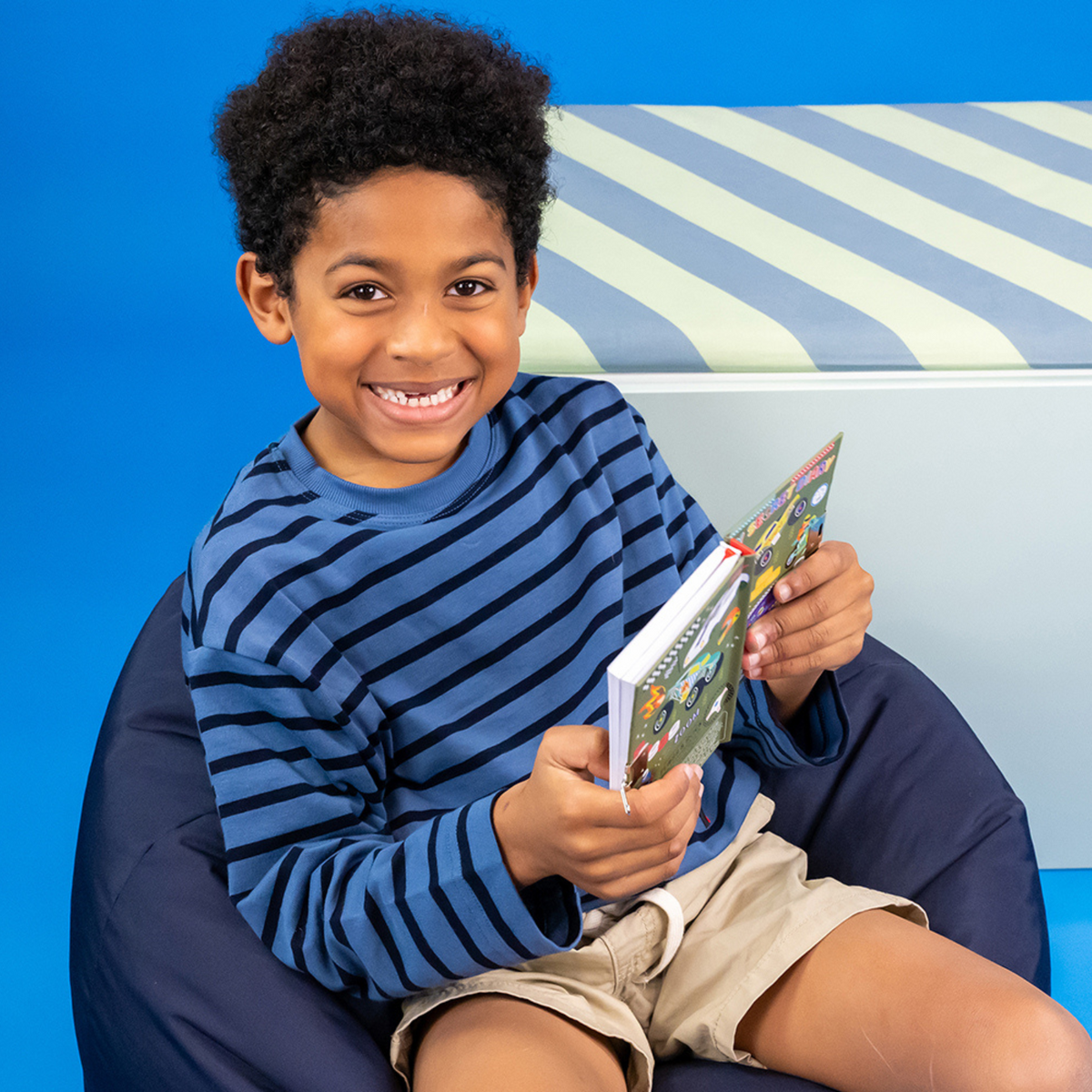 a boy sitting holding the car&#39;s diary 