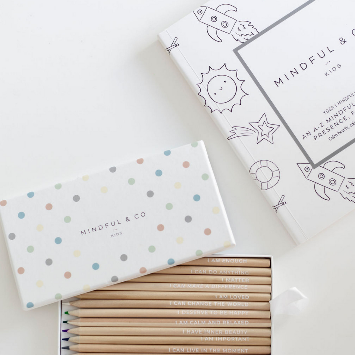 Affirmation Colouring Pencils open box next to colouring book