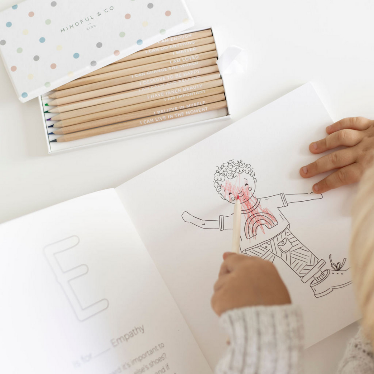 Affirmation Colouring Pencils open box next to colouring book
