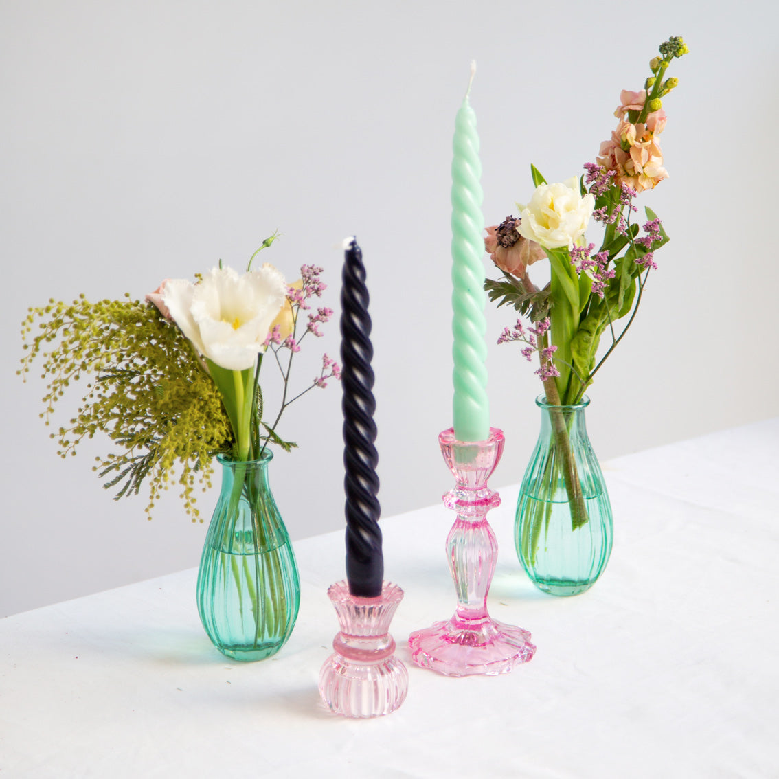 Boho Cool Coloured Spiral Candles in glass candle holders on a table