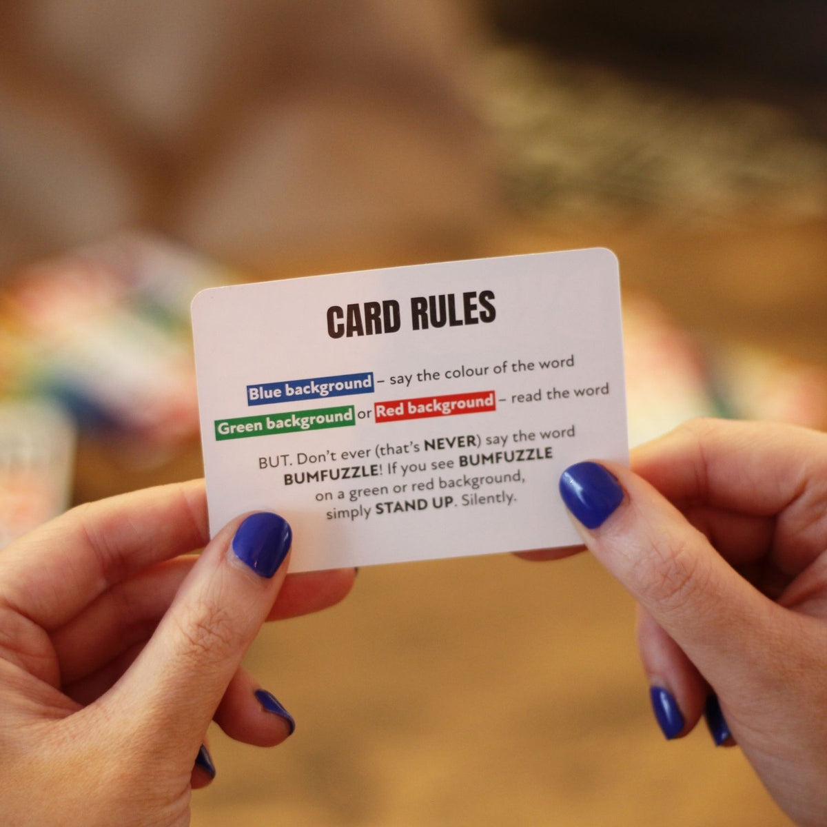 a person holding one of the game cards from bumfuzzle
