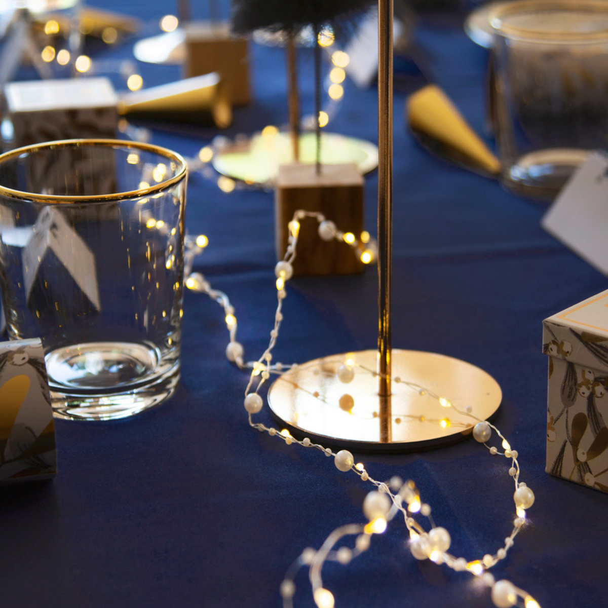 Botanical Mistletoe Bead String Lights on a table 