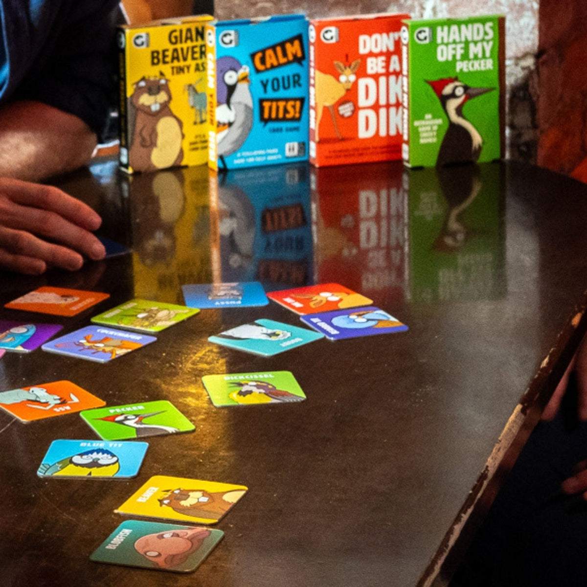 The image shows the cover of the card game &#39;Don&#39;t be a Dik Dik&#39;, featuring an illustration of a dik dik (a type of antelope) on a red background, with the title and a caution note &#39;Contains mild naughtiness&#39;.