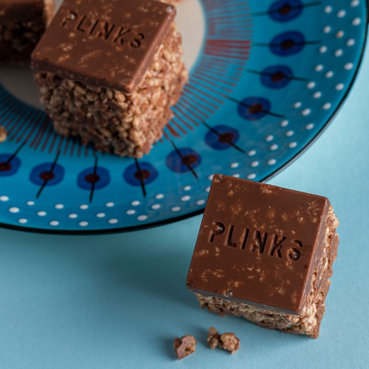 A flexible silicone jumbo ice cube mould being pressed to release a solid, chocolate raw baking megacube, demonstrating the easy-release non-stick surface.