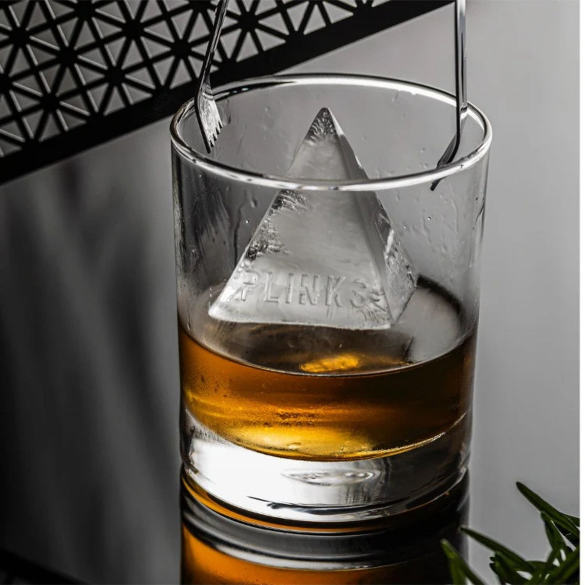 Elevate your drinks with this durable pyramid ice cube tray. Features nine large compartments and food-grade silicone for easy-release, mess-free use.