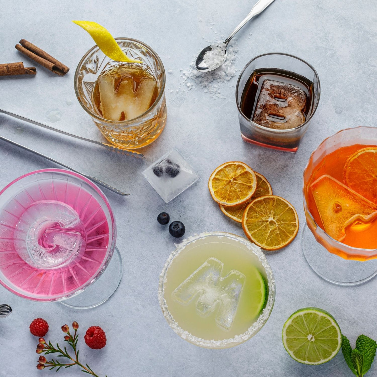 Assorted cocktails with personalised letter ice cubes and garnishes