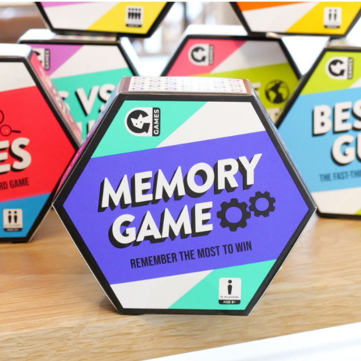 Hexagonal 'Memory Game' packaging with colorful design on a wooden surface.