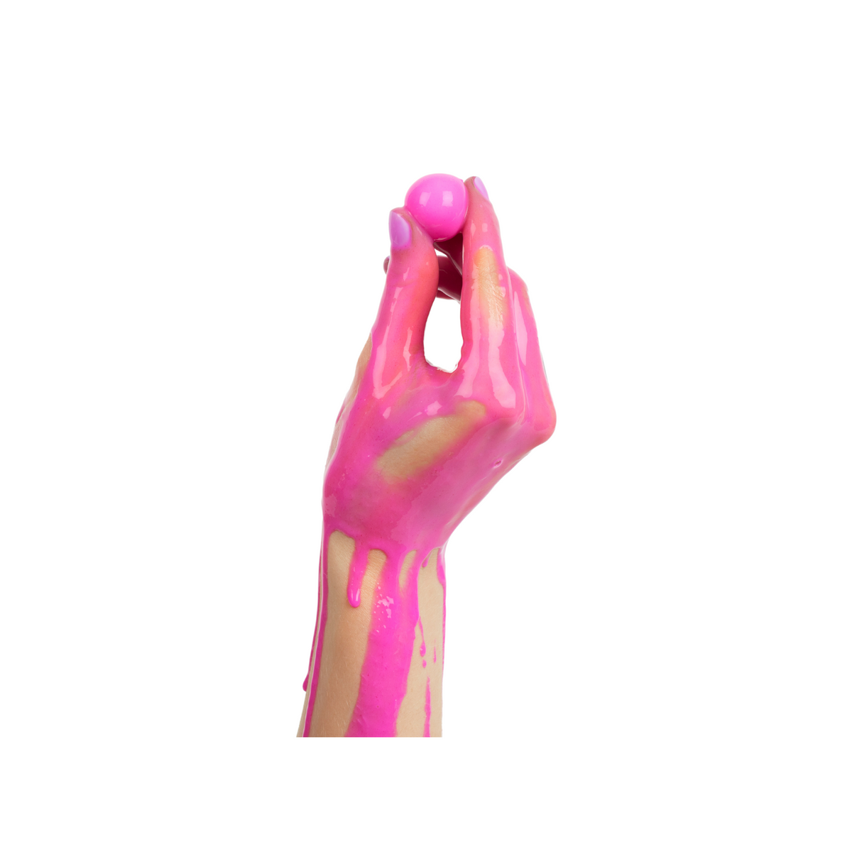 a hand holding a pink paintball with the hand covered in pink paint