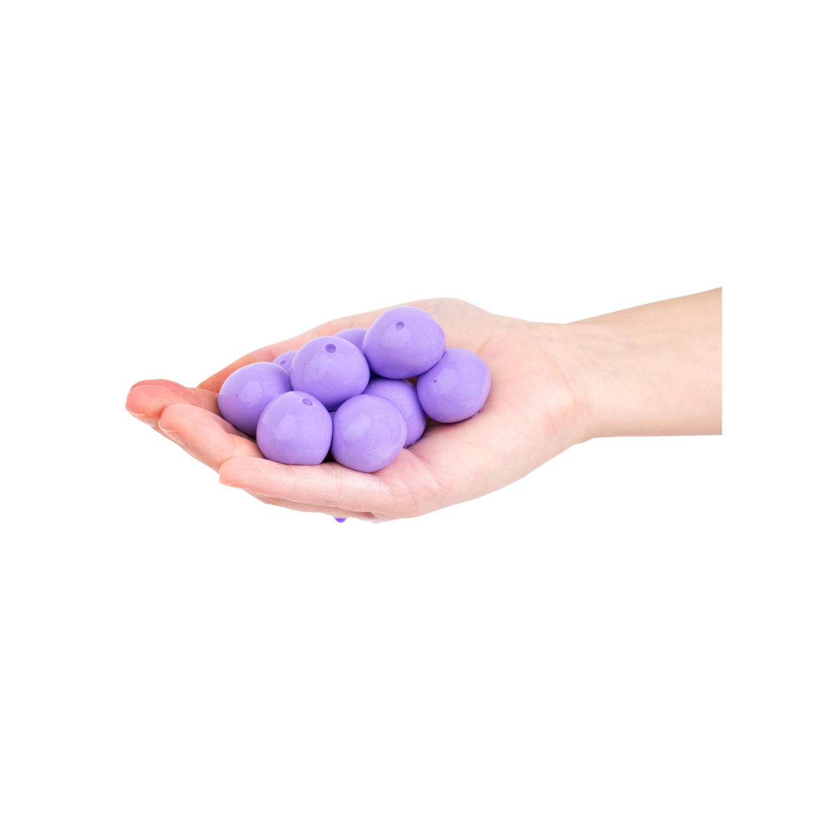 a hand holding purple goblies throwable paintballs 