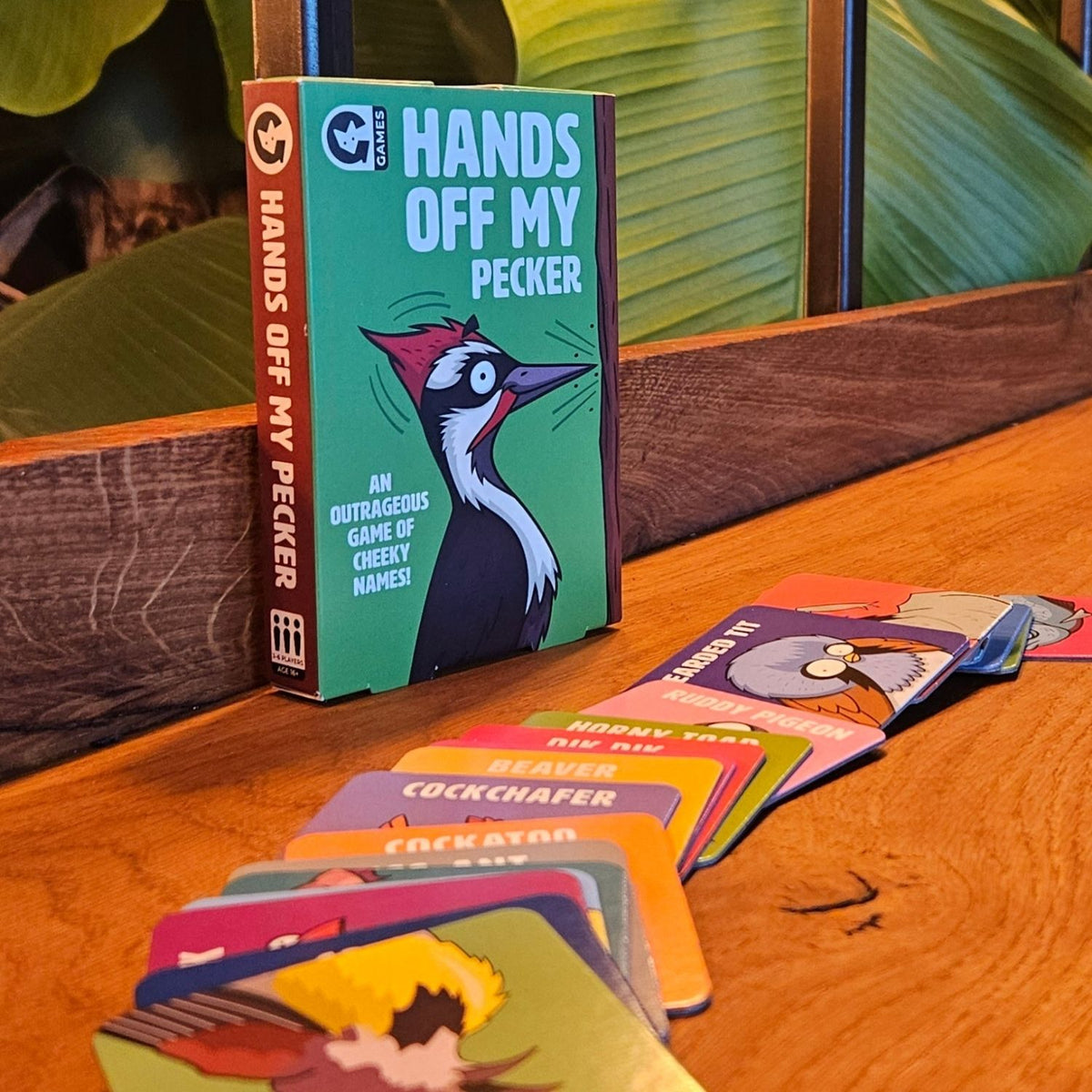 The image features the product title &quot;Hands Off My Pecker,&quot; presented in a vibrant and eye-catching design. The game&#39;s title is prominently displayed at the top in bold, black lettering, with a graphic of a peckerwood (a type of bird) looking cheeky and animated, adding a playful touch to the game&#39;s theme.