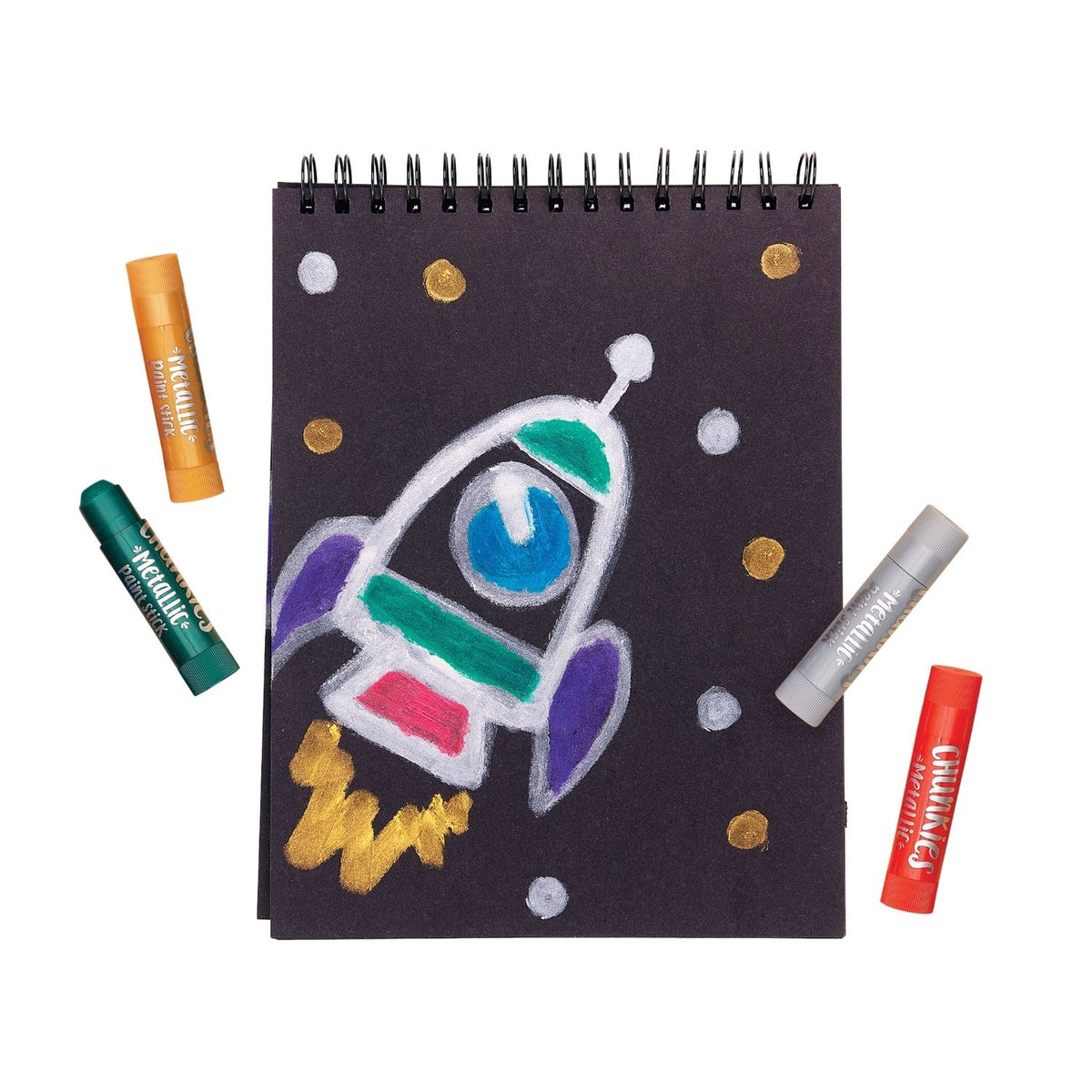 Notebook with a colourful rocket drawing using the metallic chunkies paint sticks showing how they work on both black and white paper