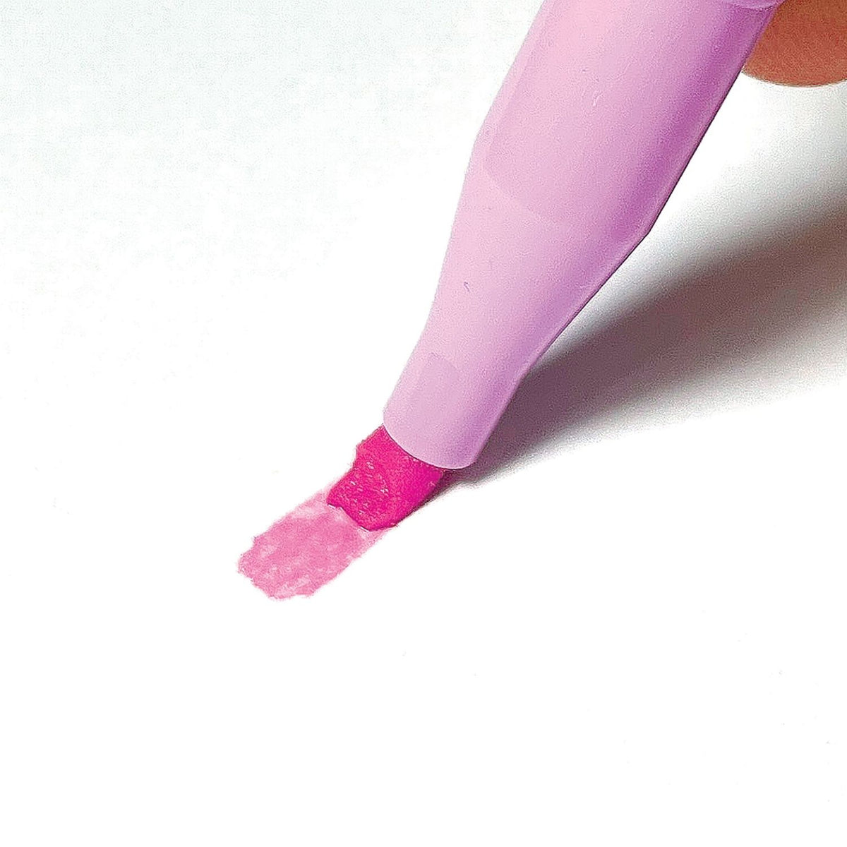 A close-up of a single pink highlighter with the cap off, highlighting the unique flexible chisel tip designed for varied line widths.