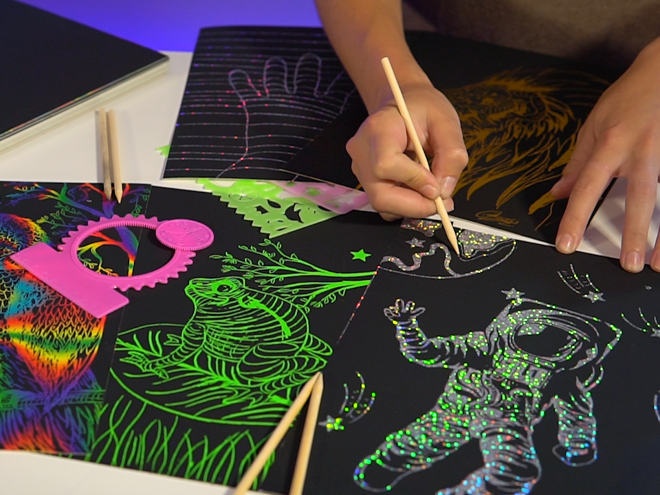 A package of Marvin&#39;s Magic Super Bright Scratch Art featuring a colorful design on the cover with a scratch art tool illustrated in the foreground.