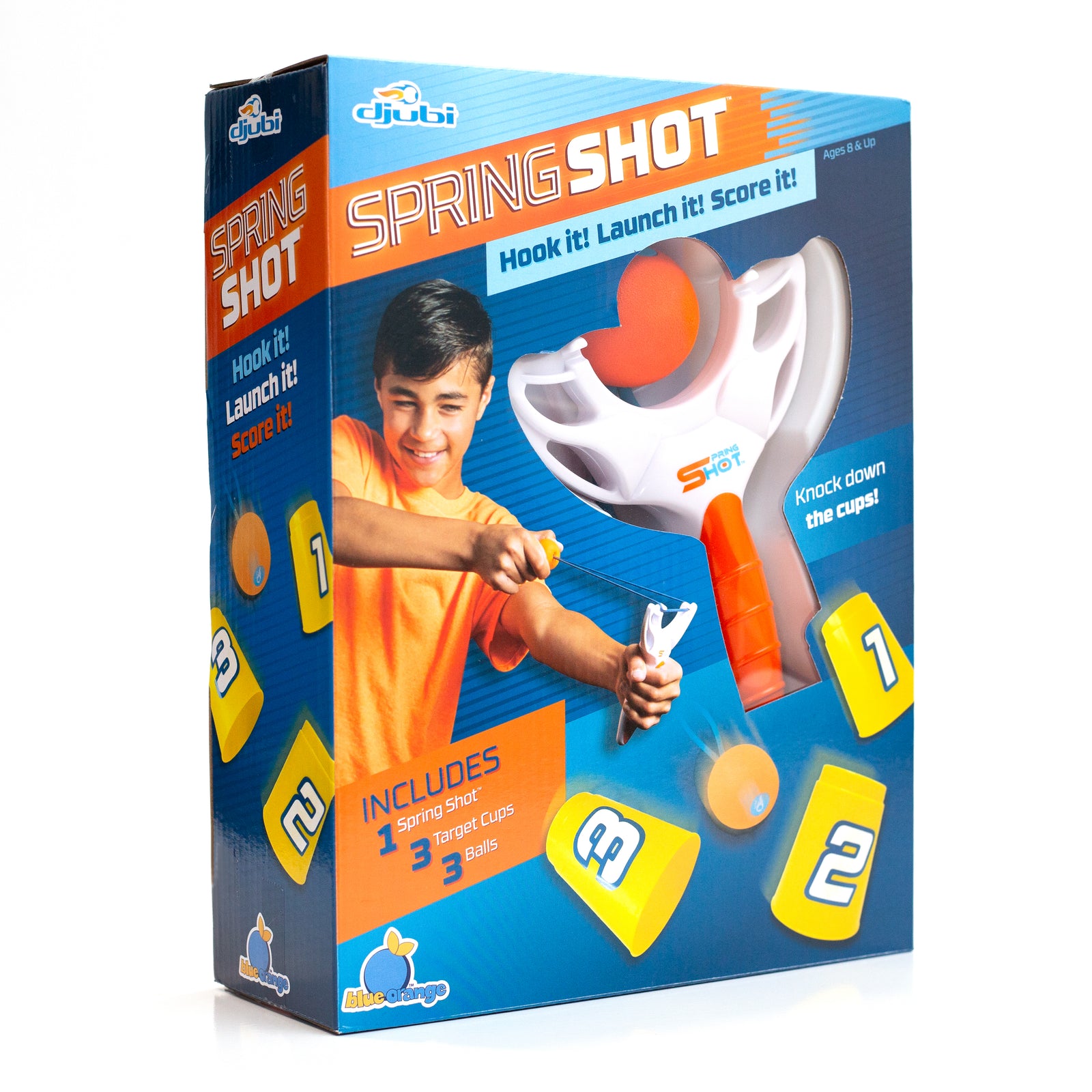 Packaging for Djubi SpringShot toy featuring the product with a boy playing and launching a ball, along with various included components like targets and a launching hook.